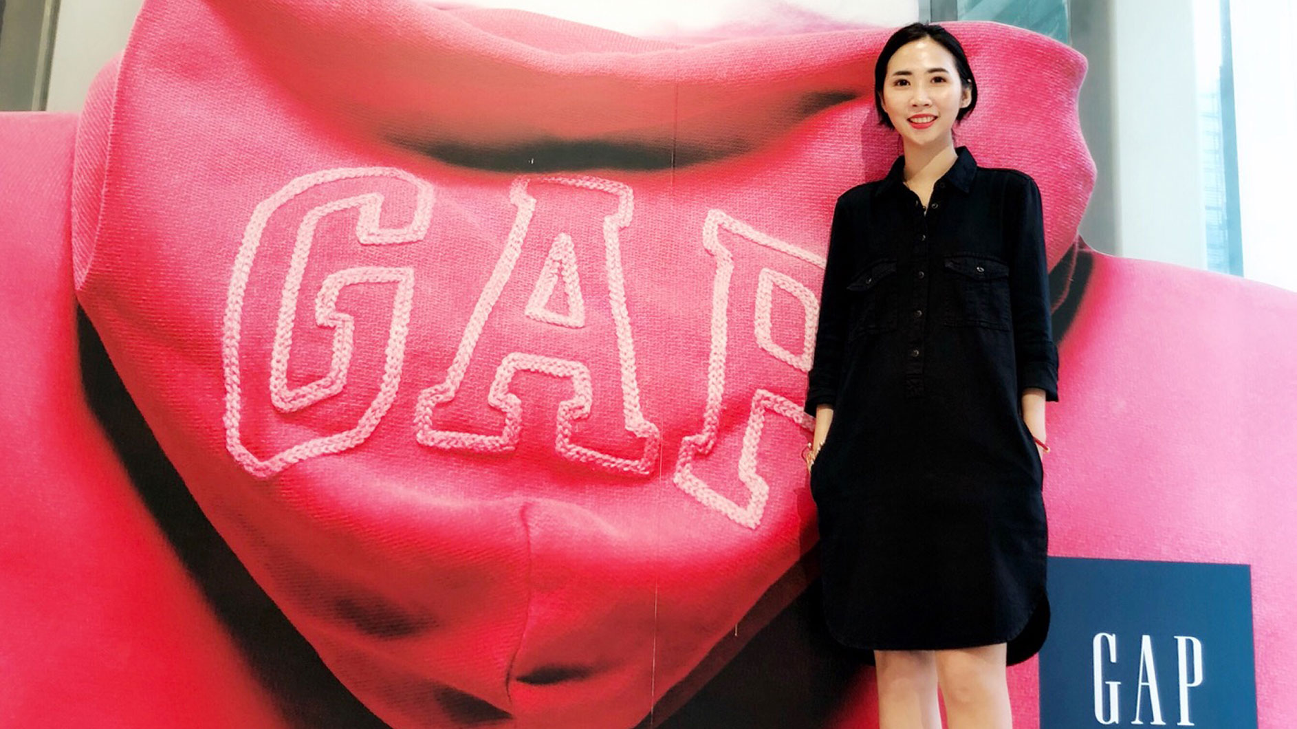 Constance Smiling in Front of Gap Logo